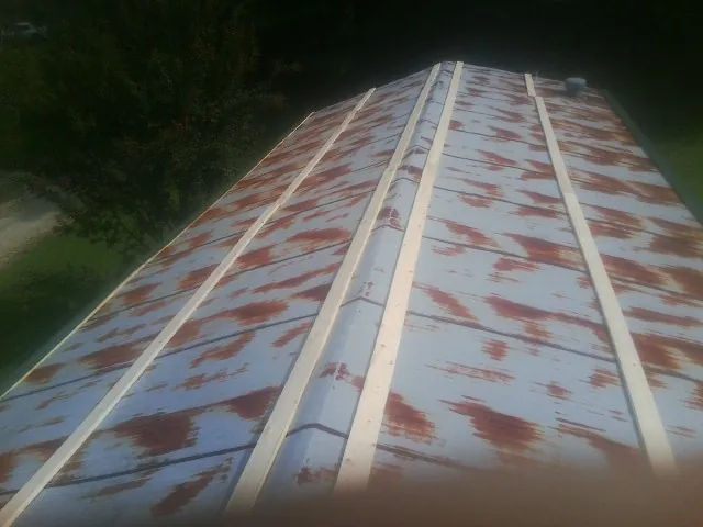 Rusted metal roof panels with new wood purlins before replacement — Storm Damage Roof Repair in Ramsey by Roofing Brothers